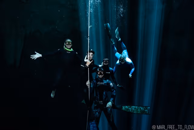 Freediver in a black swimsuit gliding underwater
